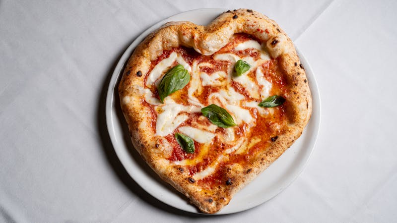 Gourmet pizza with fresh toppings and herbs